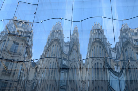 Paris, France - March 18, 2023: Buildings reflected on the new undulating glass facade of the department store Samaritaine in Paris, France.のeditorial素材