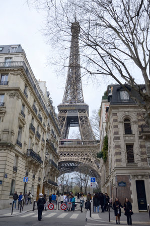 Paris, France - March 19, 2023: View of the Eiffel Tower from small street in Paris, France.のeditorial素材