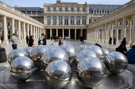 Paris, France - March 16, 2023: Big balls of plated color at Courtyard in the Royal Palace gardens of Paris, France.のeditorial素材