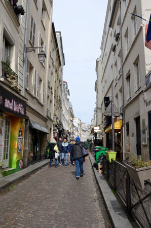 Paris, France - March 17, 2023: People in cobblestone street located in the Latin Quarter of Paris, France.のeditorial素材