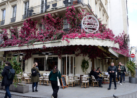 Paris, France - March 18, 2023: Traditional cafe with their tables outside at terrace in Paris, France.のeditorial素材