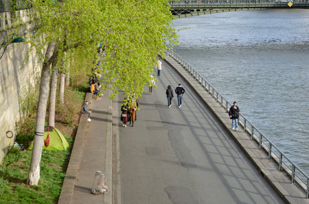 Paris, France - March 18, 2023: People walking at the banks of the river Seine seen from above in Paris, France.のeditorial素材