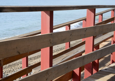 Entry to the beach from wooden littoral footpath in Marbella, Andalusia, Spain.の写真素材