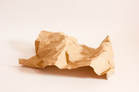 Crumpled brown paper on a white backgroundの写真素材