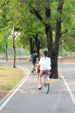 Walk in the park where a woman riding a bicycleの写真素材