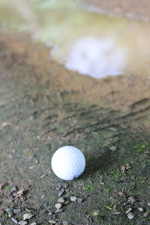 white Golf ball on green grassの写真素材