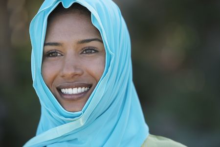 Portrait of muslim woman in blue headscarf, smilingの写真素材