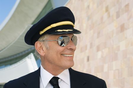 Airline pilot outside building, portrait, close upの写真素材