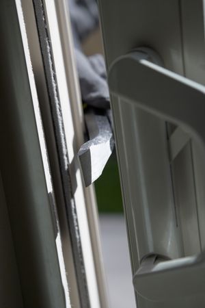 Burglar breaking into house, close-up of crowbarの写真素材