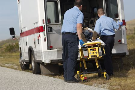 Paramedics transporting victim on stretcherの写真素材