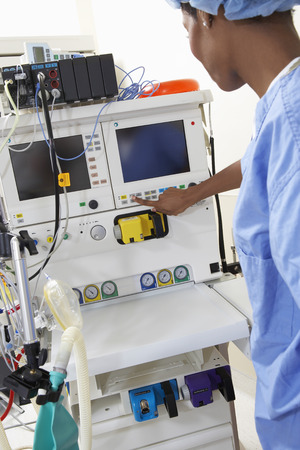 Female surgeon operating medical equipmentの写真素材