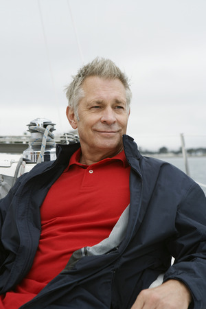 Man relaxing on yacht, portraitの写真素材
