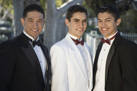 Portrait of three men wearing tuxedos outdoors