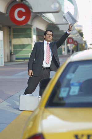 Businessman hailing taxiの写真素材