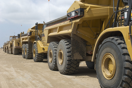 Row of trucks at landfill siteの写真素材
