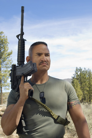 Portrait of soldier with machine gun