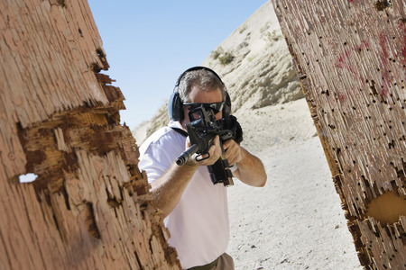 Man aiming machine gun at firing range