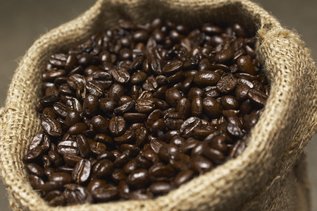 Coffee beans in sack, close-upの写真素材