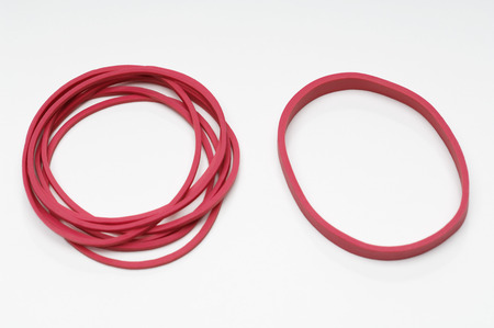 Red rubber bands on white background
