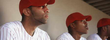 Baseball players sitting in dugoutの写真素材