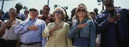 Crowd of people during national anthem, outdoors