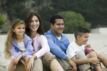 Family relaxing on beachの写真素材