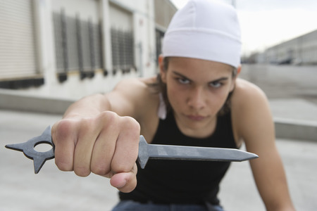Young man posing with knifeの写真素材