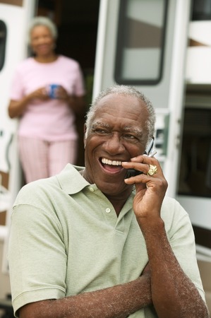 Middle-Aged Man Keeping in Touch During RV Tripの写真素材