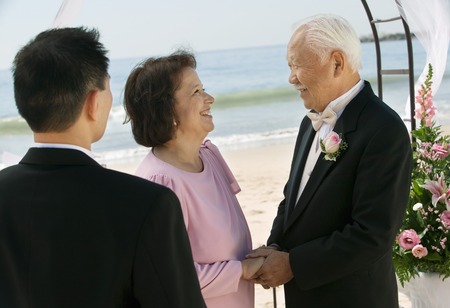 Groom With Parents on Beachの写真素材