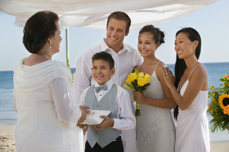 Bride and Groom on Beach With Familyの写真素材