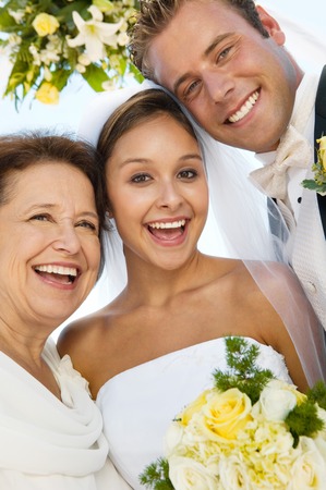 Bride and Groom With Mother on Beachの写真素材