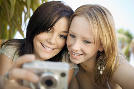 Friends Looking at Digital Cameraの写真素材