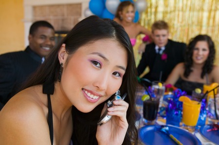 Teenage Girl at Party Using Cell Phoneの写真素材