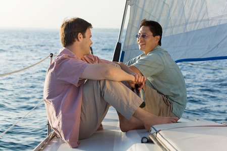 Friends Sitting on Sailboatの写真素材