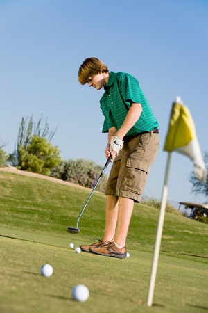 Golfer Putting on Practice Greenの写真素材