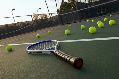 Tennis Racket and Balls on Court