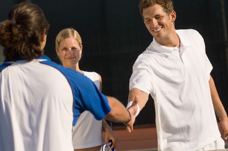 Tennis Players Shaking Hands at Netの写真素材