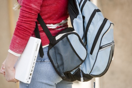 Mid section of a female student wearing backpack