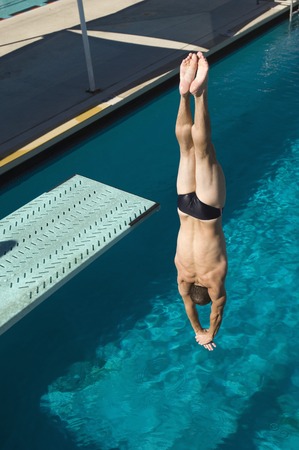 Young man diving into swimming poolの写真素材