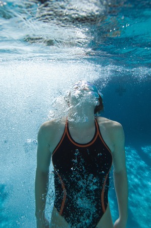 Young female swimmer in swimming poolの写真素材