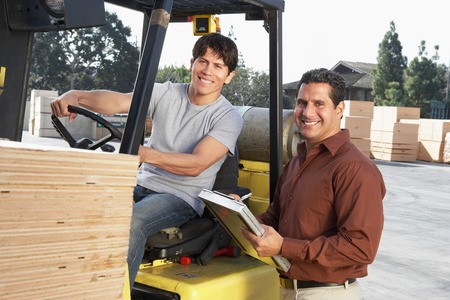 Manager with Forklift Driver at Lumber Warehouse