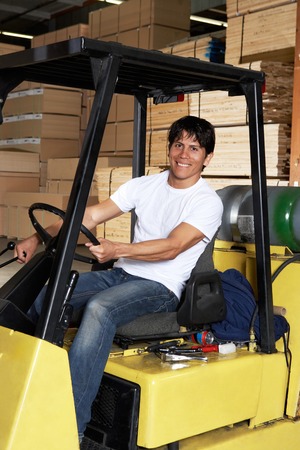 Driver on Forklift in Lumber Warehouse