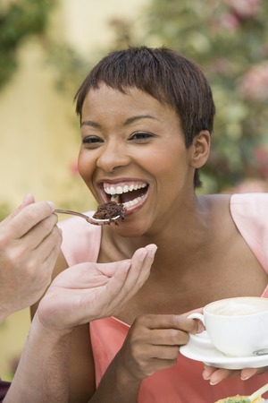 Woman sharing dessert outdoors