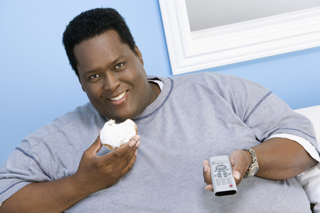 Overweight man watching television