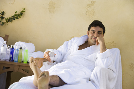 Portrait of man in bathrobe, relaxing outdoorsの写真素材