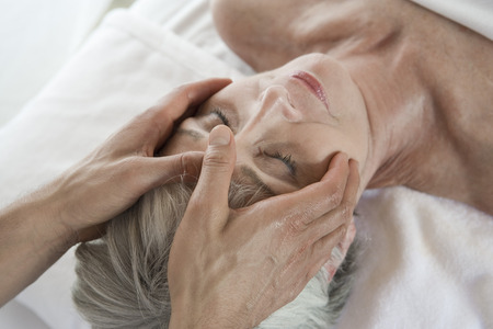 Senior woman having head massageの写真素材