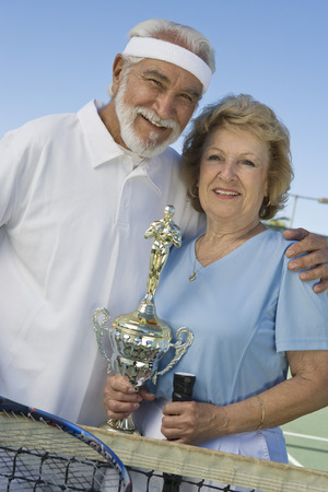 Tennis players with award cupの写真素材