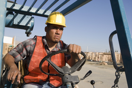Construction worker driving vehicle