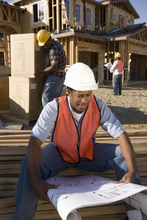 Construction worker showing direction to another worker steering vehicle