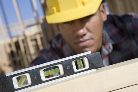 Construction worker using spirit level